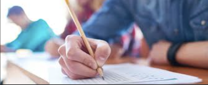  Student holding pencil taking a test