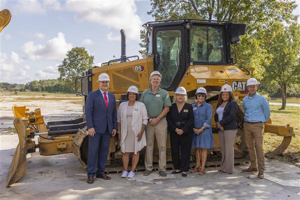 RSS School Board poses in front of bulldozer. 