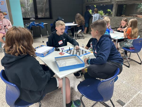 students in classroom playing chess